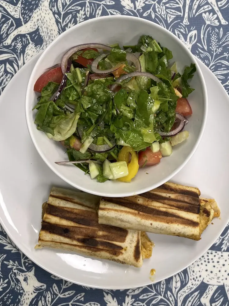 Grilled wraps with a bowl of green salad